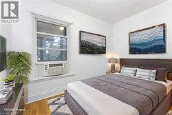 Bedroom featuring light wood finished floors and baseboards - 