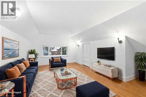 Living area with wood finished floors and lofted ceiling - 180 Emerald Street S, Hamilton, ON - Indoor Photo Showing Living Room