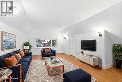 Living area with wood finished floors and lofted ceiling - 