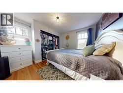 Primary bedroom with bright windows and closet space - 