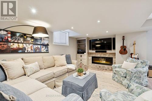 Renovated Rec Room- Above Grade Windows & Pot Lts! - 407 Seneca Court, Newmarket, ON - Indoor Photo Showing Living Room With Fireplace