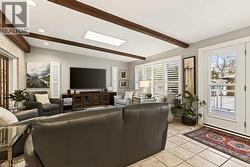 Great Room to enjoy warm natural light with the almost floor to ceiling windows* Skylight * walkout to the rear deck and the stunning backyard! Stunning views all Year, even in winter;) - 