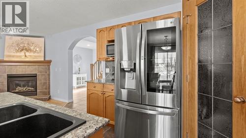 158 Covemeadow Road Ne, Calgary, AB - Indoor Photo Showing Kitchen With Fireplace With Double Sink