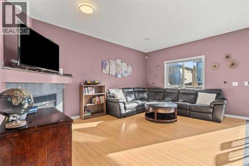 15 Chapalina Close Se, Calgary, AB - Indoor Photo Showing Living Room With Fireplace