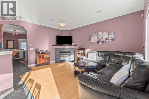 15 Chapalina Close Se, Calgary, AB - Indoor Photo Showing Living Room With Fireplace