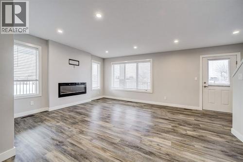 Living Room - 203 1 Street, Shaughnessy, AB - Indoor Photo Showing Other Room With Fireplace