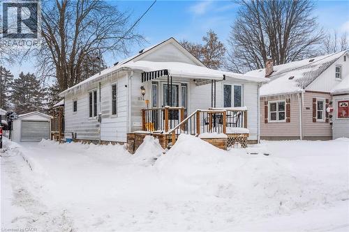 View of front of property featuring an outdoor structure, a chimney, and a garage - 234 Head Street N, Simcoe, ON - Outdoor