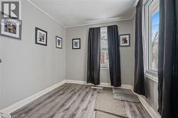 Unfurnished room featuring light wood-style flooring and ornamental molding - 