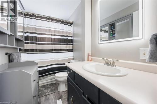Bathroom with vanity, a shower with shower curtain, and dark wood finished floors - 234 Head Street N, Simcoe, ON - Indoor Photo Showing Bathroom