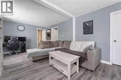 Living area with a desk and wood finished floors - 