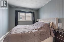 Bedroom featuring wood walls - 