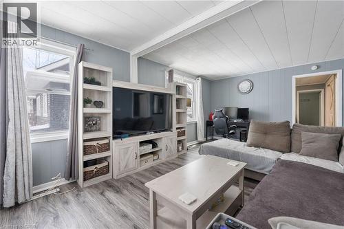 Living room featuring a desk, wood finished floors, wooden walls, and beam ceiling - 234 Head Street N, Simcoe, ON - Indoor Photo Showing Living Room
