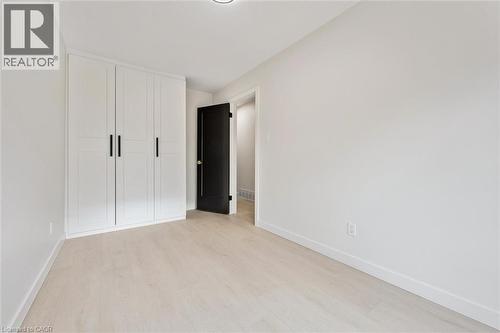 Unfurnished bedroom with a closet and light wood-style flooring - 459 Drummerhill Crescent, Waterloo, ON - Indoor Photo Showing Other Room