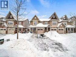 View of front of house featuring covered porch, a garage, and stone siding - 
