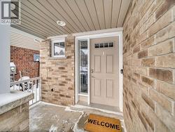 Doorway to property featuring brick siding - 