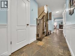 Hallway featuring baseboards and stone tile floors - 