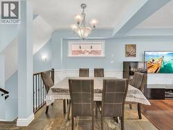 Dining space with a chandelier, a textured ceiling, and vaulted ceiling - 