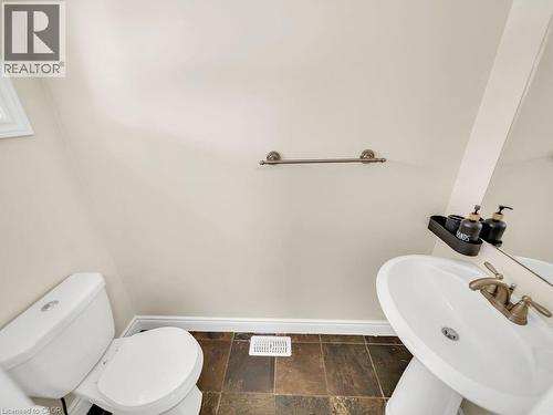 Half bathroom with a sink and stone tile flooring - 29 Amsterdam Crescent, Guelph, ON - Indoor Photo Showing Bathroom