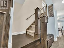Staircase featuring baseboards and a high ceiling - 