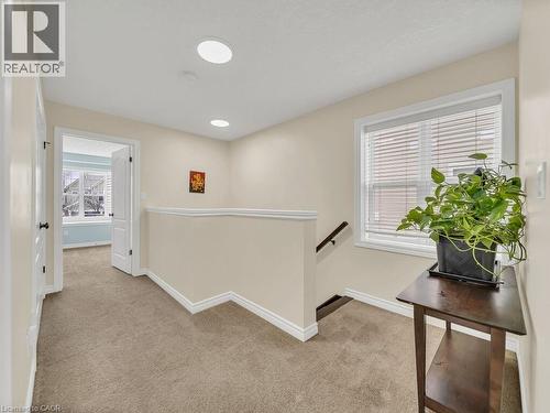 Corridor with an upstairs landing, light colored carpet, plenty of natural light, and recessed lighting - 29 Amsterdam Crescent, Guelph, ON - Indoor Photo Showing Other Room