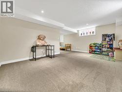 Playroom featuring carpet flooring and a textured ceiling - 