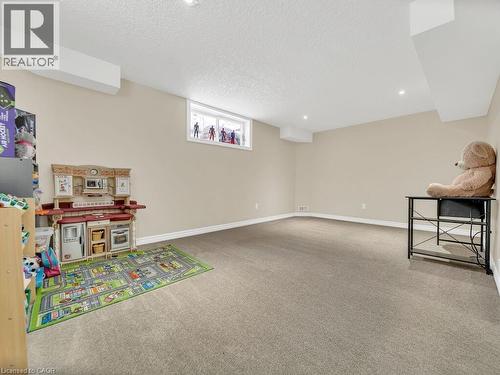 Recreation room with light carpet, a textured ceiling, and recessed lighting - 29 Amsterdam Crescent, Guelph, ON - Indoor