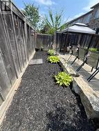 Fenced backyard featuring a gazebo and a patio area - 