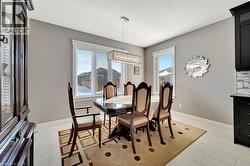 Dining room with a textured ceiling and a chandelier - 