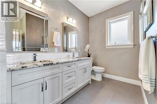 Bathroom featuring double vanity and light tile patterned floors - 107 Forbes Crescent, Listowel, ON - Indoor Photo Showing Bathroom