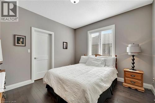 Bedroom featuring baseboards and dark wood finished floors - 107 Forbes Crescent, Listowel, ON - Indoor Photo Showing Bedroom