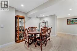 Dining area featuring light wood finished floors and recessed lighting - 