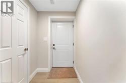 Doorway to outside with baseboards and wood finished floors - 