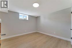 Below grade area featuring baseboards and light wood-type flooring - 