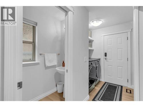 Powder Room and Laundry - 2455 Quail Ridge Boulevard Unit# 213, Kelowna, BC - Indoor Photo Showing Laundry Room
