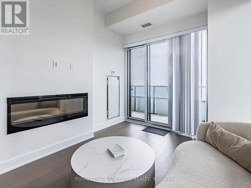 4701 - 20 Shore Breeze Drive, Toronto, ON - Indoor Photo Showing Living Room With Fireplace