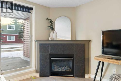 4104, 10 Prestwick Bay Se, Calgary, AB - Indoor Photo Showing Living Room With Fireplace