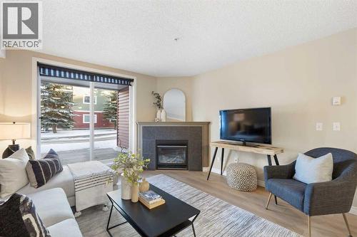4104, 10 Prestwick Bay Se, Calgary, AB - Indoor Photo Showing Living Room With Fireplace
