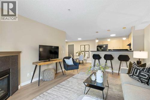 4104, 10 Prestwick Bay Se, Calgary, AB - Indoor Photo Showing Living Room With Fireplace