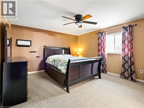 Bedroom featuring carpet, a textured ceiling, and ceiling fan - 47 Schroder Crescent, Guelph, ON - Indoor Photo Showing Bedroom