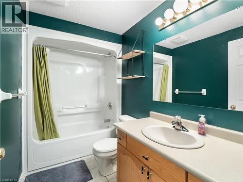 Full bathroom with vanity, shower / tub combo, a textured ceiling, and light tile patterned floors - 47 Schroder Crescent, Guelph, ON - Indoor Photo Showing Bathroom