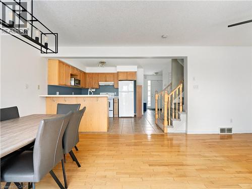Dining space featuring stairway, light wood-style flooring, and a textured ceiling - 47 Schroder Crescent, Guelph, ON - Indoor