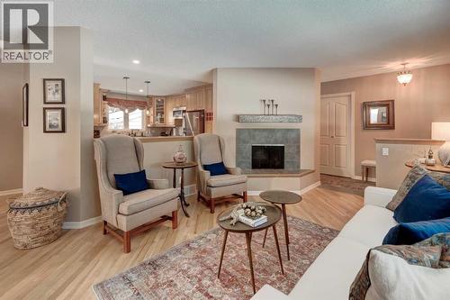 9 Mountain Place, Okotoks, AB - Indoor Photo Showing Living Room With Fireplace