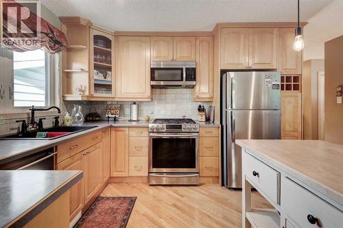 9 Mountain Place, Okotoks, AB - Indoor Photo Showing Kitchen With Double Sink