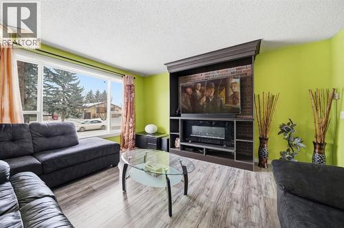 6411 26 Avenue Ne, Calgary, AB - Indoor Photo Showing Living Room With Fireplace