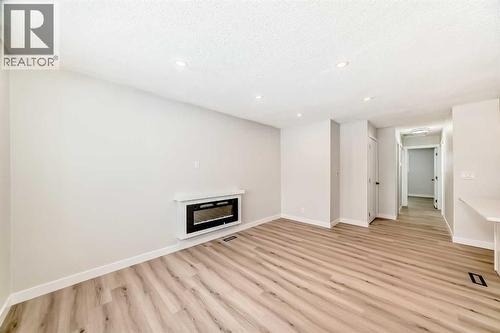 937 Marcombe Drive Ne, Calgary, AB - Indoor With Fireplace