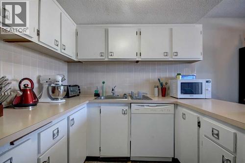 602, 2200 Woodview Drive Sw, Calgary, AB - Indoor Photo Showing Kitchen With Double Sink