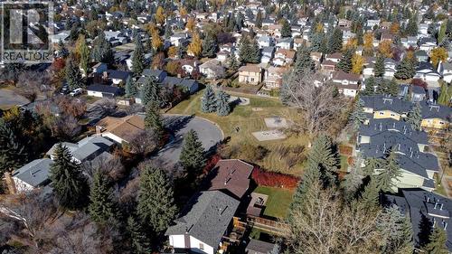 Playground borders Sierra Gardens on the west side - 602, 2200 Woodview Drive Sw, Calgary, AB - Outdoor With View