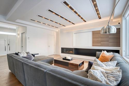 Salon - 50 Rue De L'Oiselet, Carignan, QC - Indoor Photo Showing Living Room With Fireplace