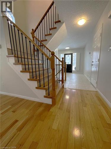 Foyer featuring light wood-style flooring, stairs, and a textured ceiling - 443 Lausanne Crescent, Waterloo, ON - Indoor Photo Showing Other Room