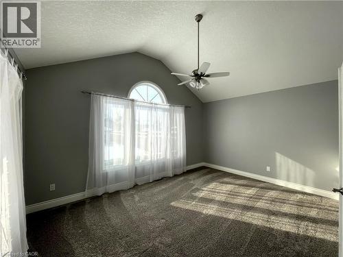 Carpeted spare room featuring vaulted ceiling, a textured ceiling, and a ceiling fan - 443 Lausanne Crescent, Waterloo, ON - Indoor Photo Showing Other Room